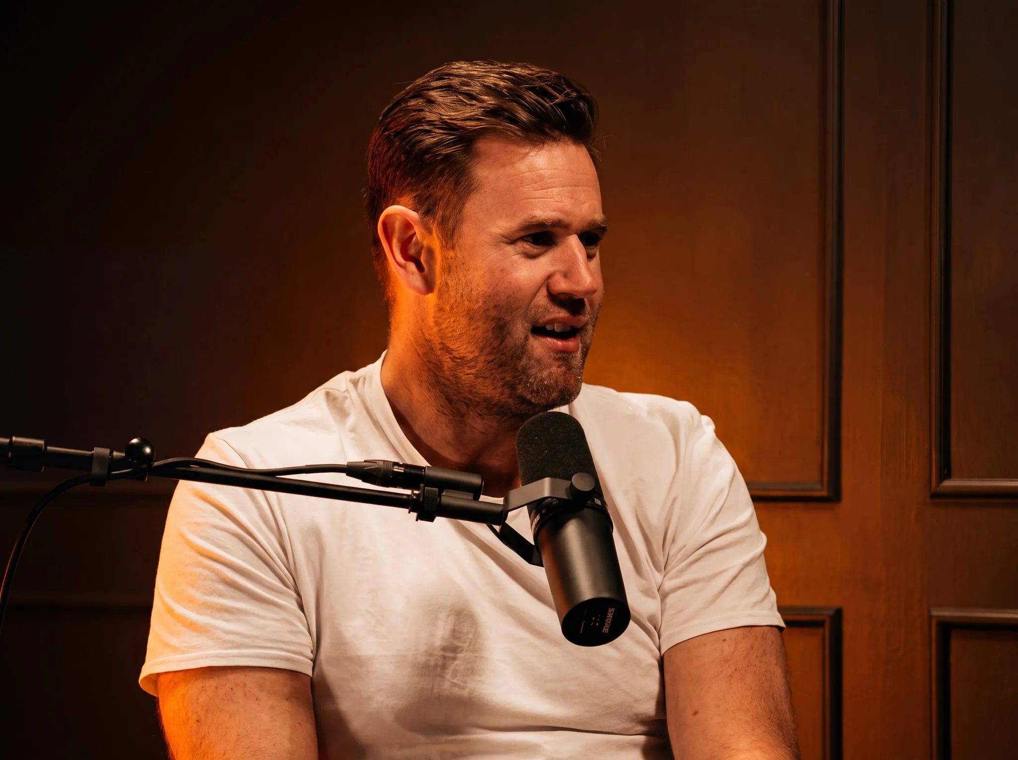 Allan Draper recording the Bug Bux Podcast at a studio microphone