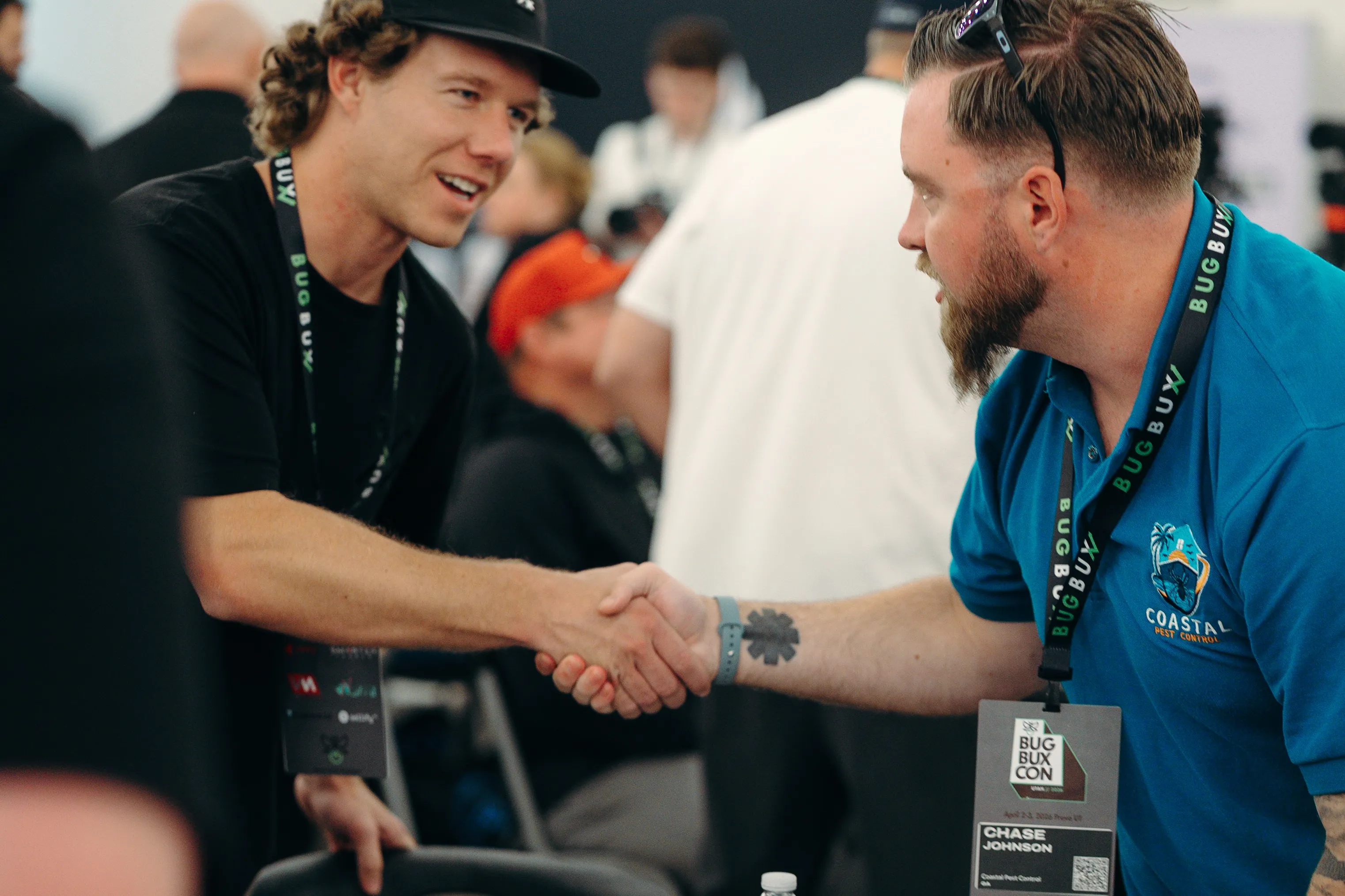 Two pest control owners shaking hands at Bug Bux Con