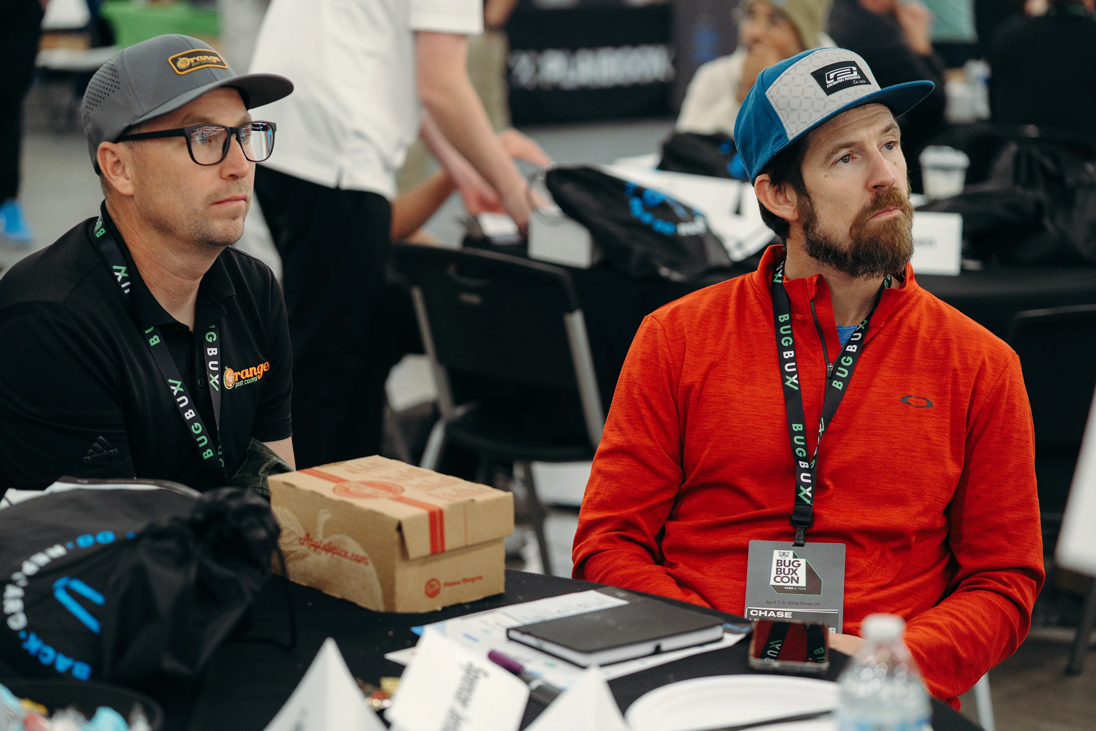 Owners taking notes at a table during Bug Bux Con
