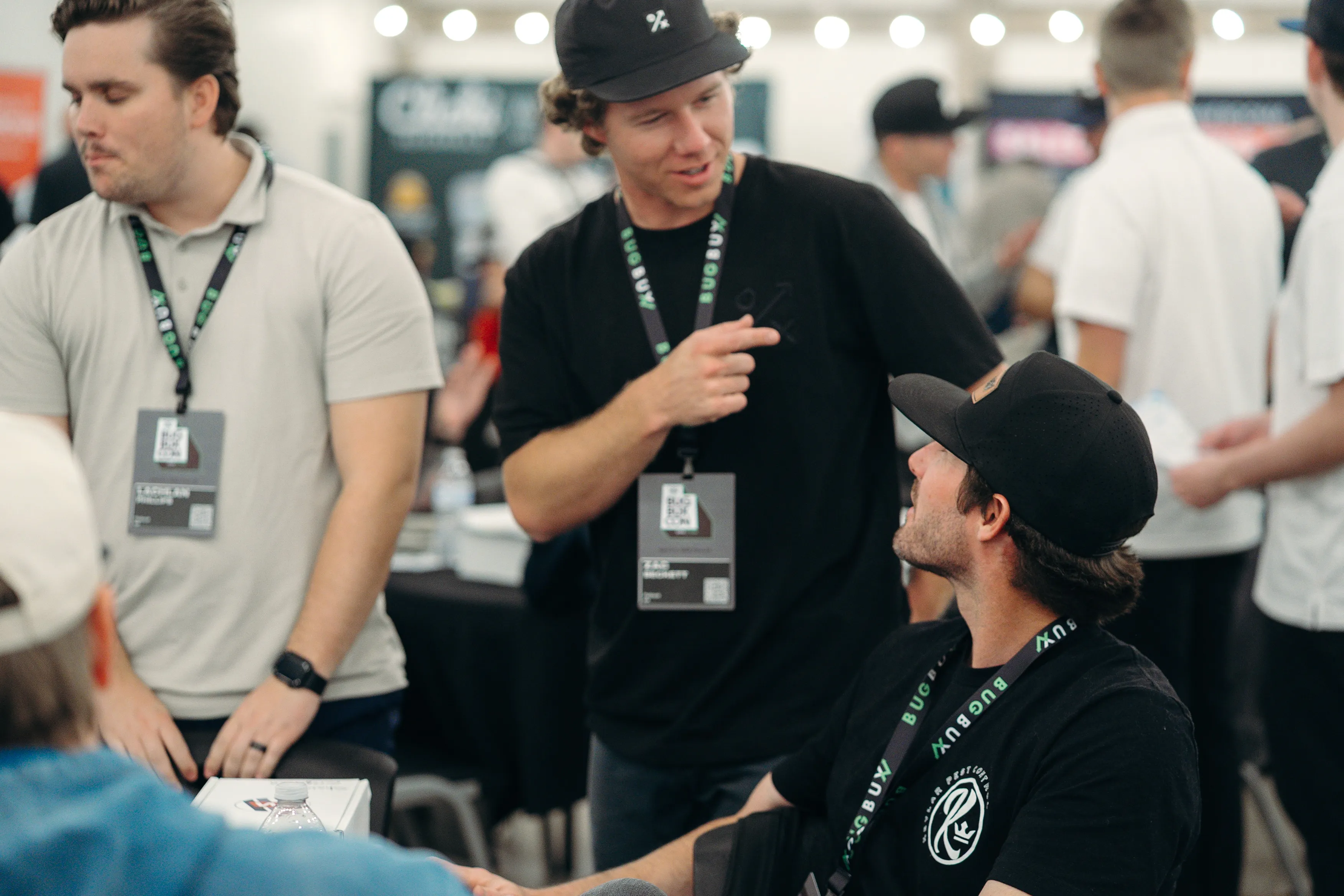 Pest control owners laughing together at Bug Bux Con