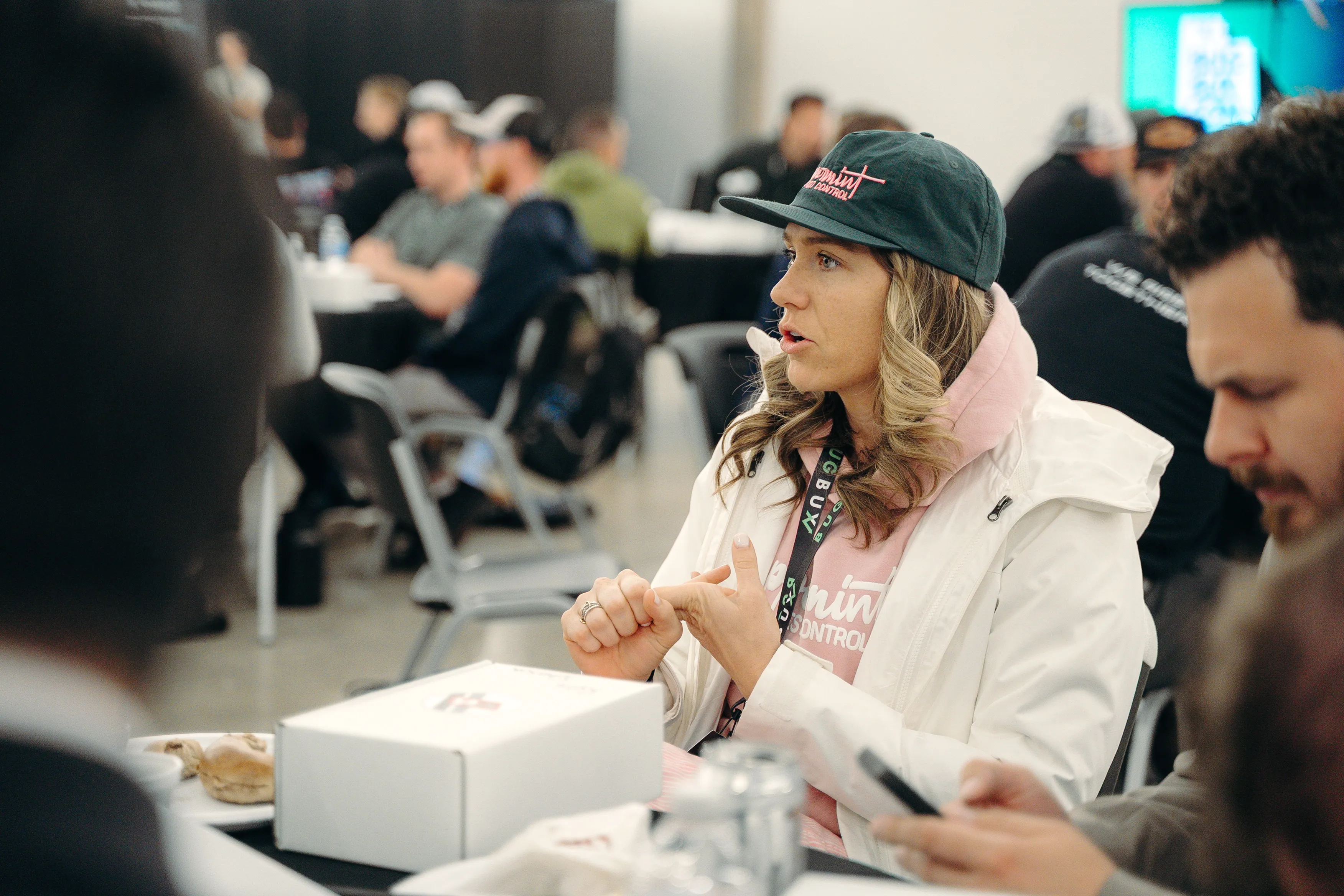 A pest control business owner talking with others at a Bug Bux event